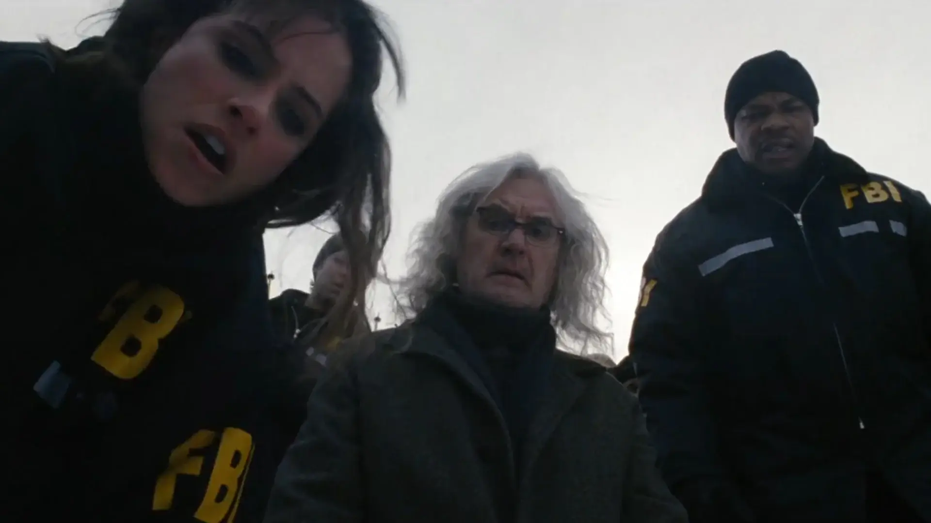 Amanda Peet, Billy Connolly, and Xzibit look down together in shock in The X-Files: I Want to Believe.