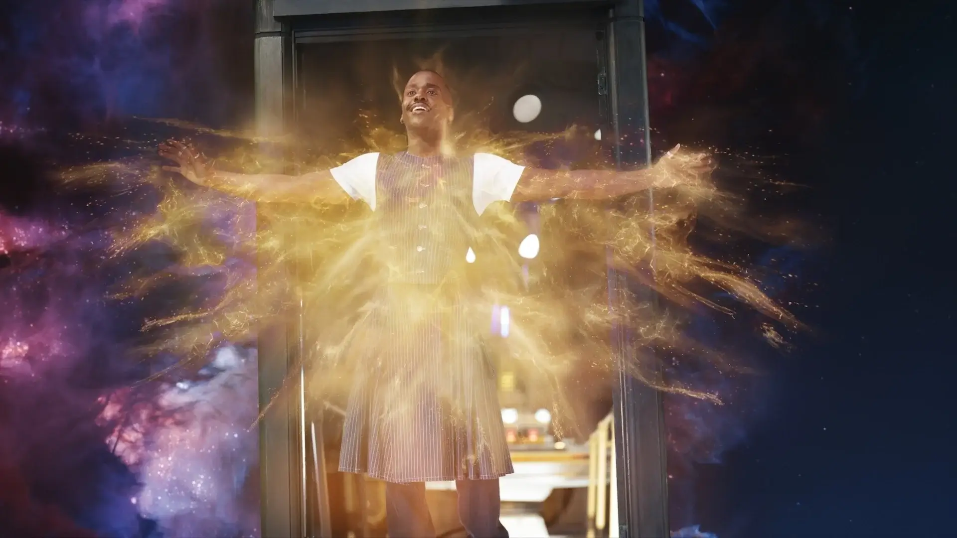 A regenerating Ncuti Gatwa stands in the TARDIS doorway with arms open to the galaxy in Doctor Who, Season 15 Episode 8 - "The Reality War."