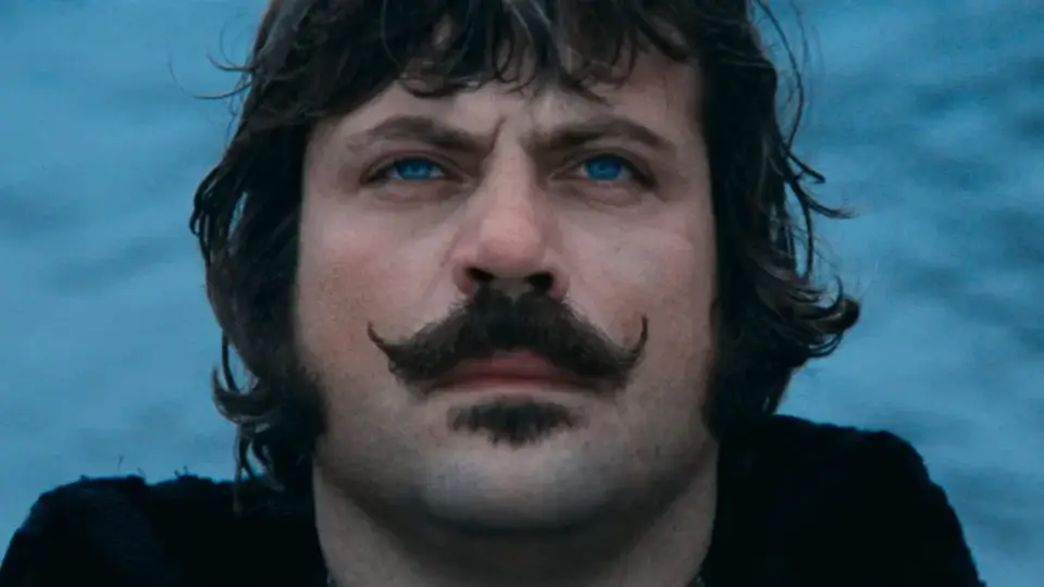 Oliver Reed looks up with foreboding while standing in front of the water in Ken Russell's The Devils.