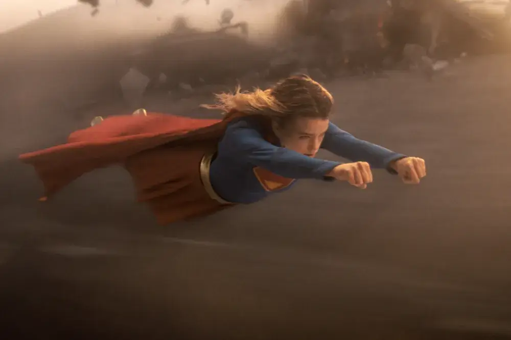 Milly Alcock as Supergirl flying.