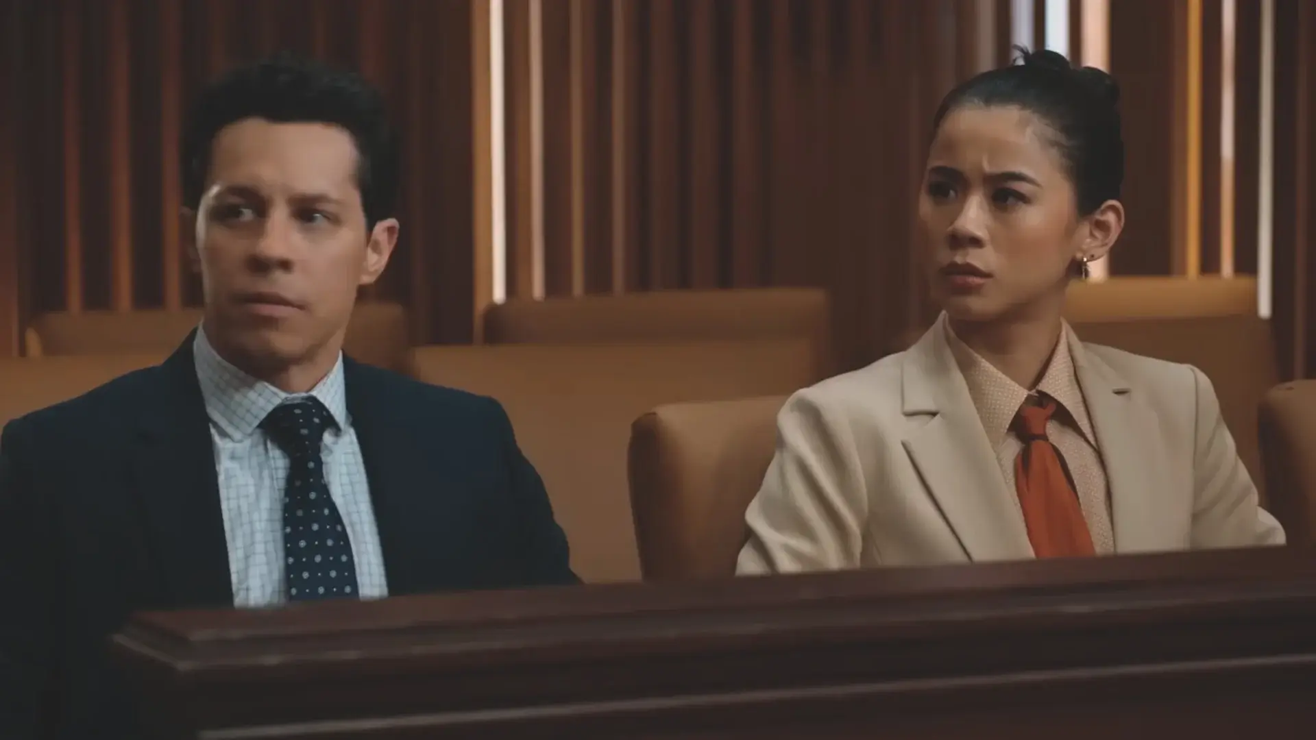A concerned David Del Rio and Sarah Lewis sit together in court in Matlock's Season 2 Trailer.