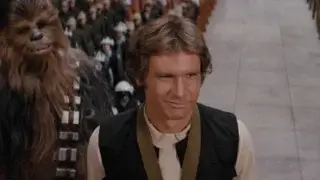 Harrison Ford smiles as he stands with a medal around his neck in Star Wars: Episode IV - A New Hope.