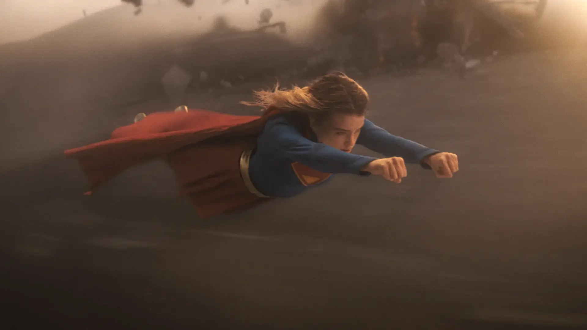 A determined Milly Alcock soars through the air in Supergirl.
