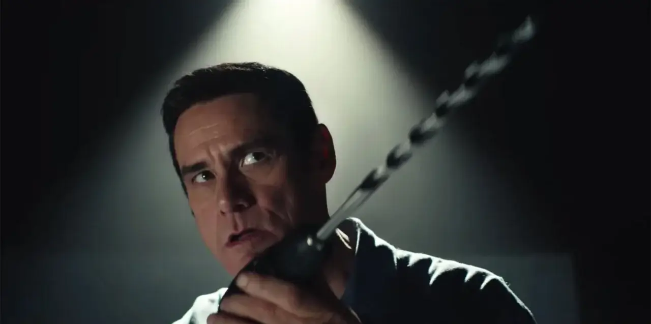 Jim Carrey looking scary with a drill.