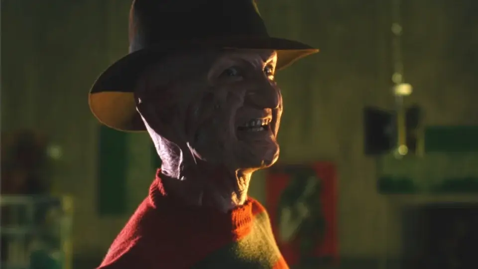 Robert Englund stands by a boiler smiling menacingly in Freddy's Dead: The Final Nightmare.
