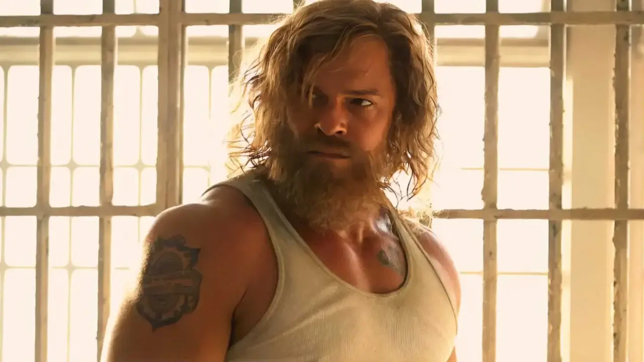 Alan Ritchson with long hair and a beard in Motor City.
