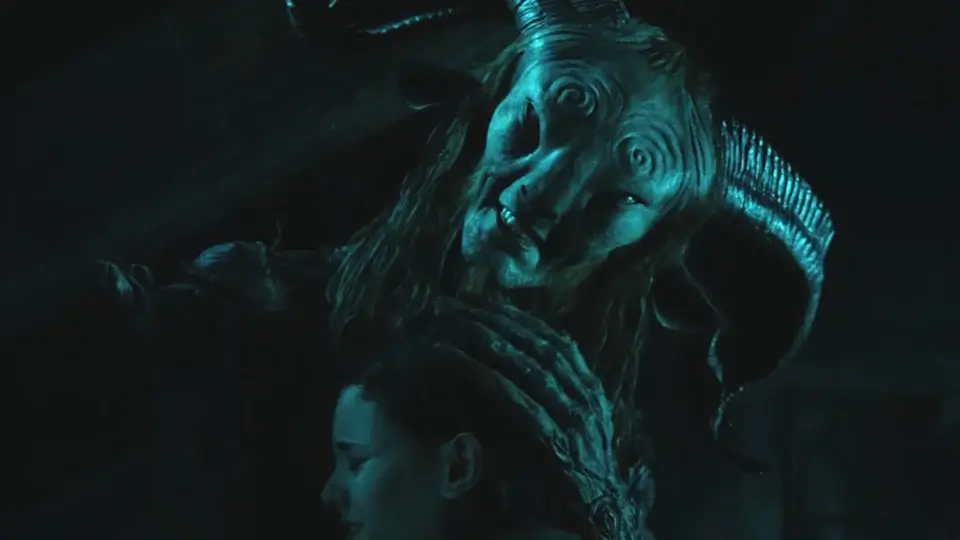 Doug Jones in full Fauno makeup embraces Ivana Baquero outside at night in Pan's Labyrinth.