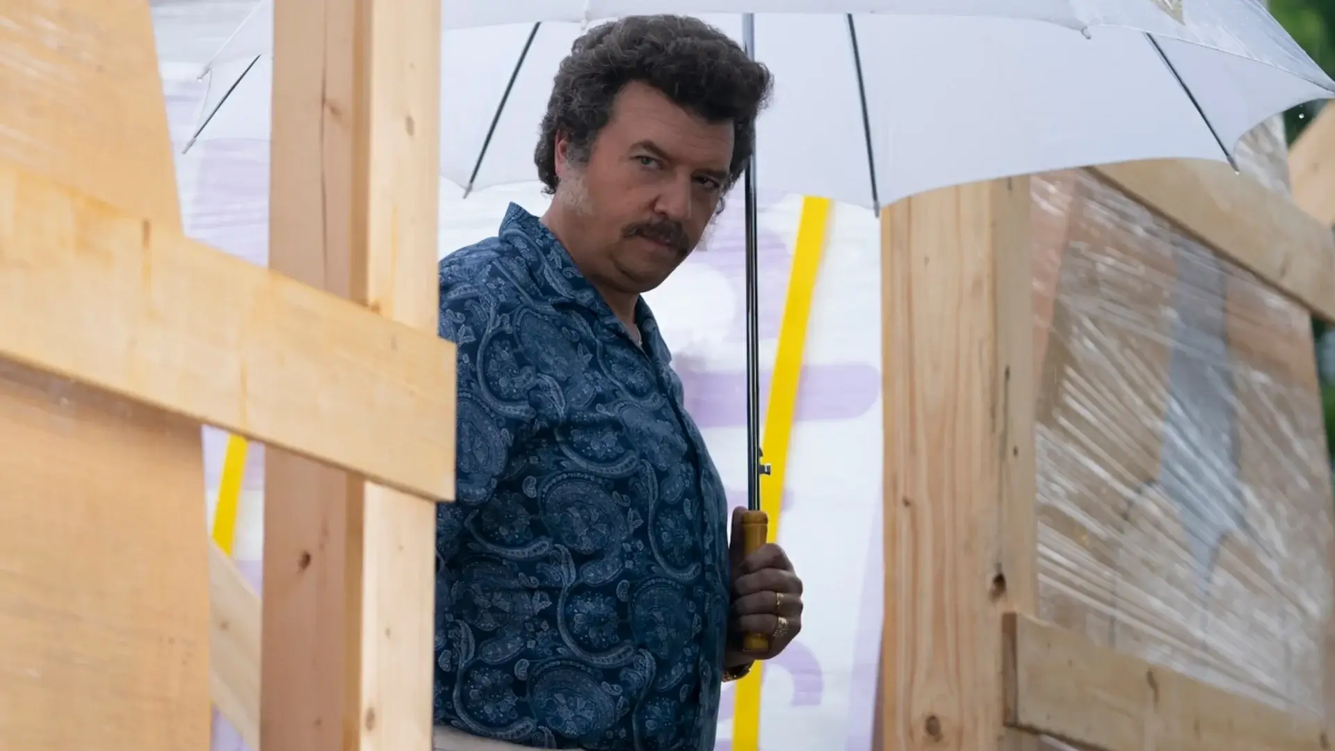 Danny McBride suspiciously watches something while holding a white umbrella in The Righteous Gemstones - Season 4, Episode 3 - "To Grieve Like the Rest of Men Who Have No Hope."