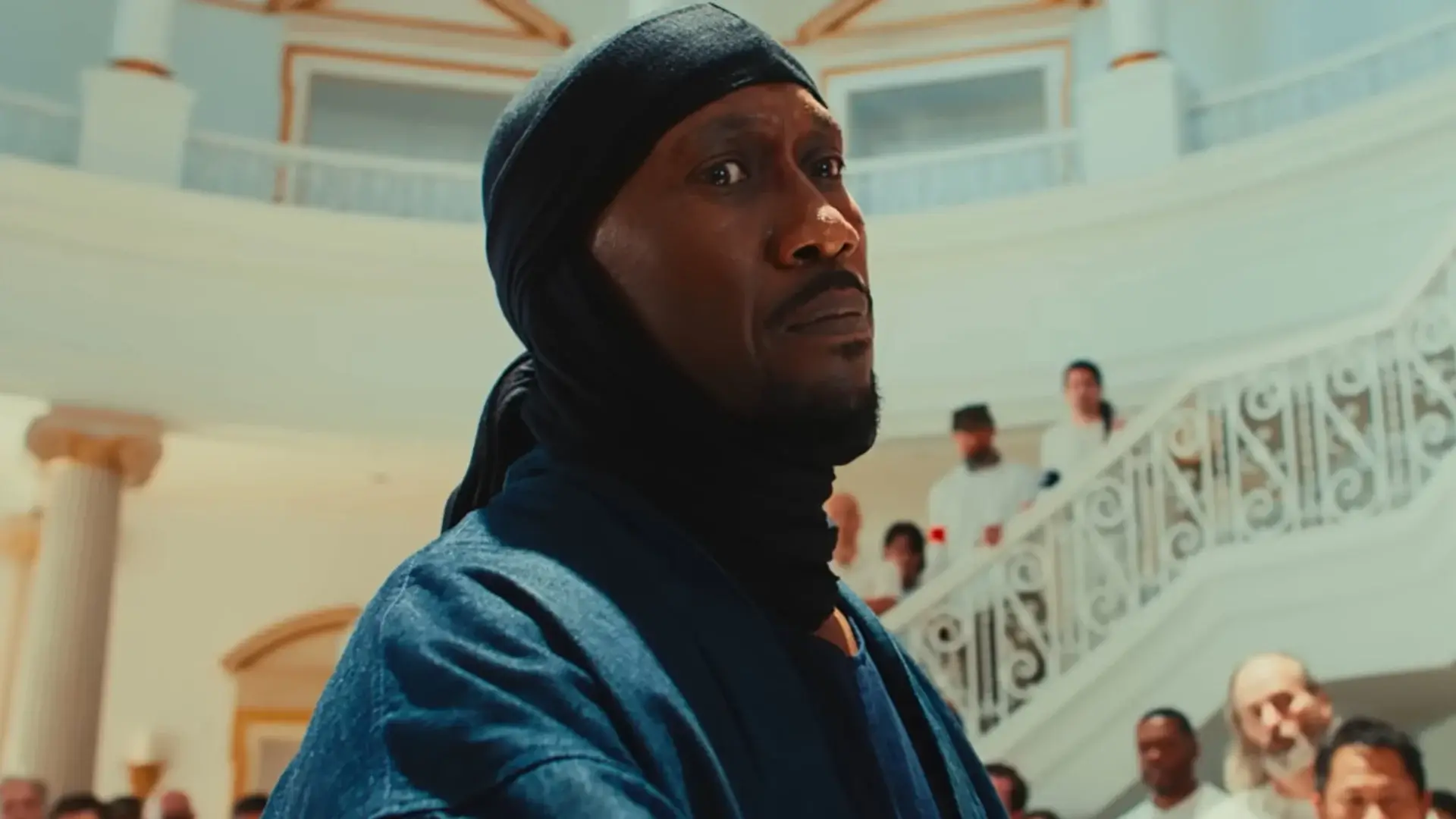 Mahershala Ali looks down with a melancholy expression in Your Mother Your Mother Your Mother.