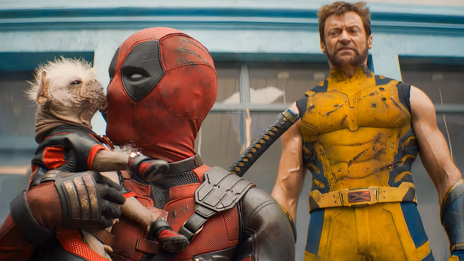 Dogpool licks Ryan Reynolds as Deadpool while Hugh Jackman as Wolverine watches in "Wolverine & Deadpool"