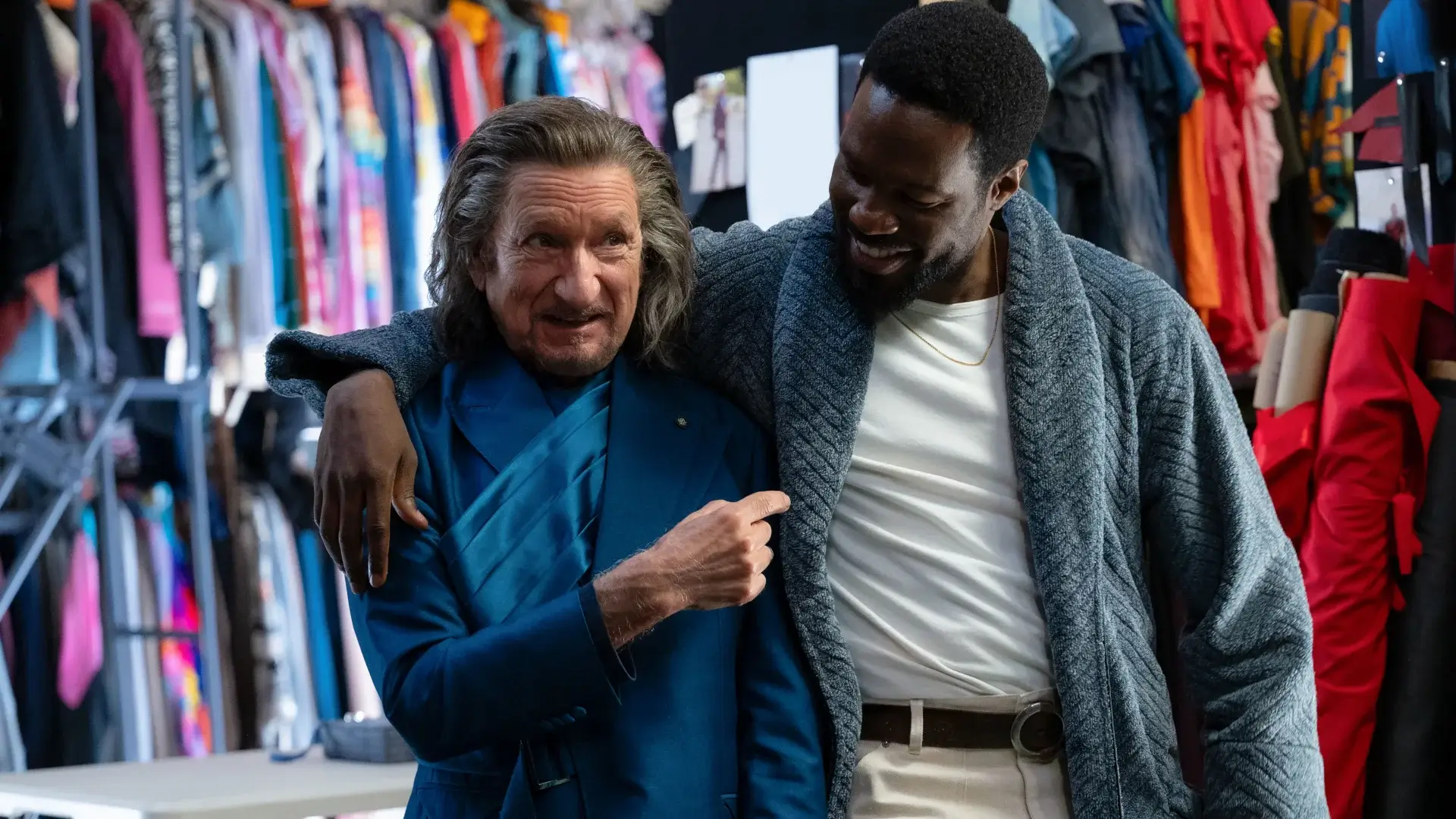 Ben Kingsley stands laughing with a smiling Yahya Abdul-Mateen II's arm around him in Wonder Man.