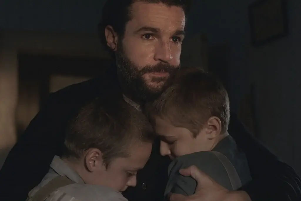 Abbott cradling his family.