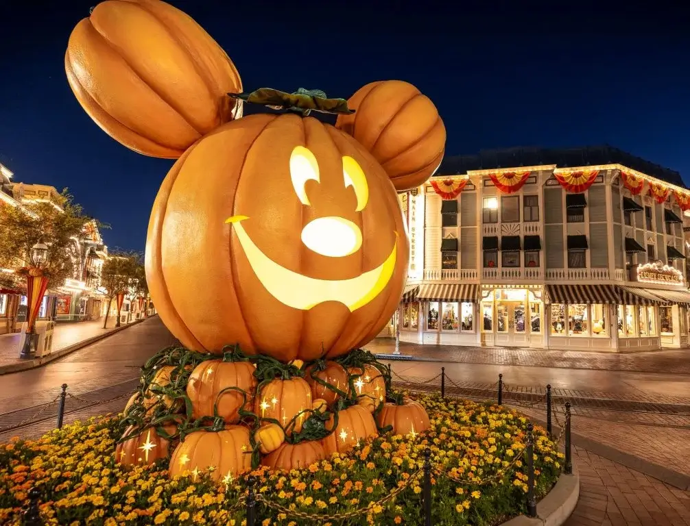 Disney-inspired carving at the Main Street Pumpkin Festival, anchored by the iconic giant Mickey Mouse pumpkin.