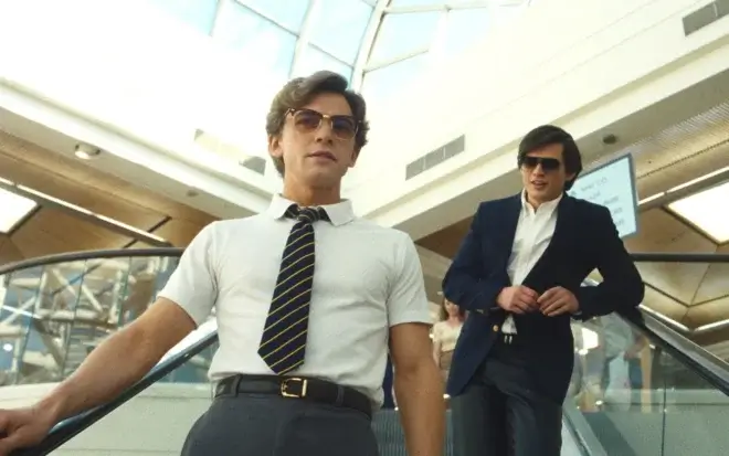 two men standing on an escalator