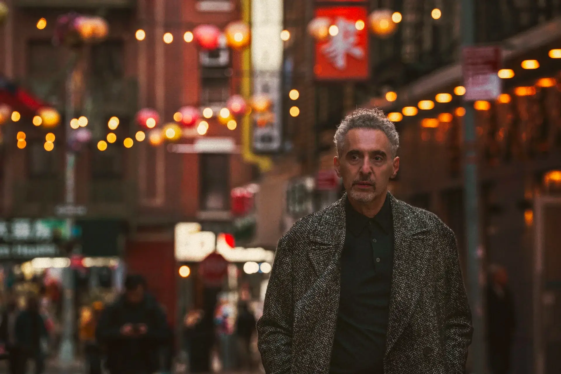 Man walking in a city at night.