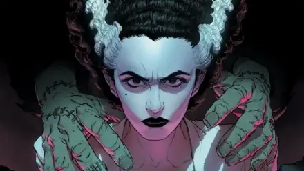 Pale woman stares out with a pair of hands on her shoulders.