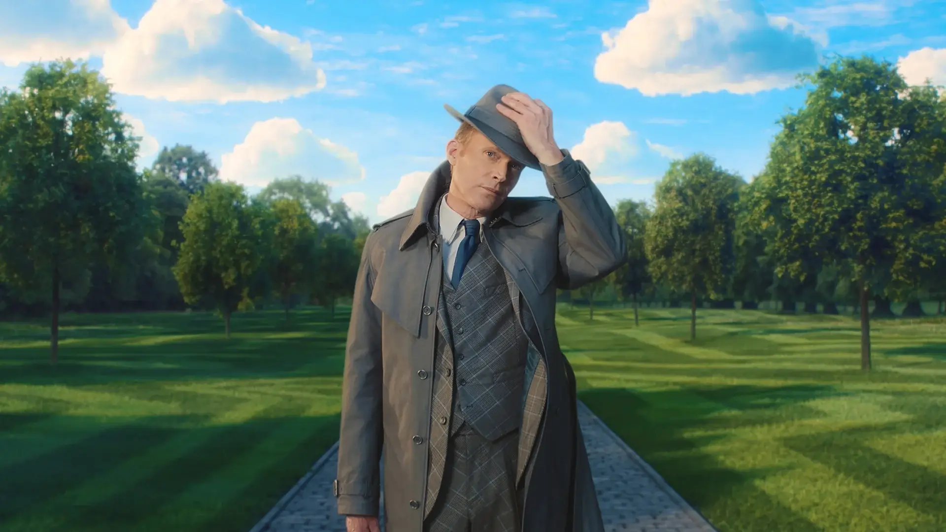 Man in a jacket and hat outside.