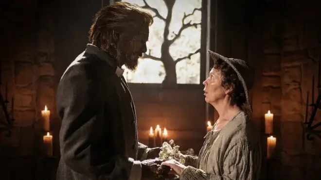 A golem and a woman look into each other's eyes.