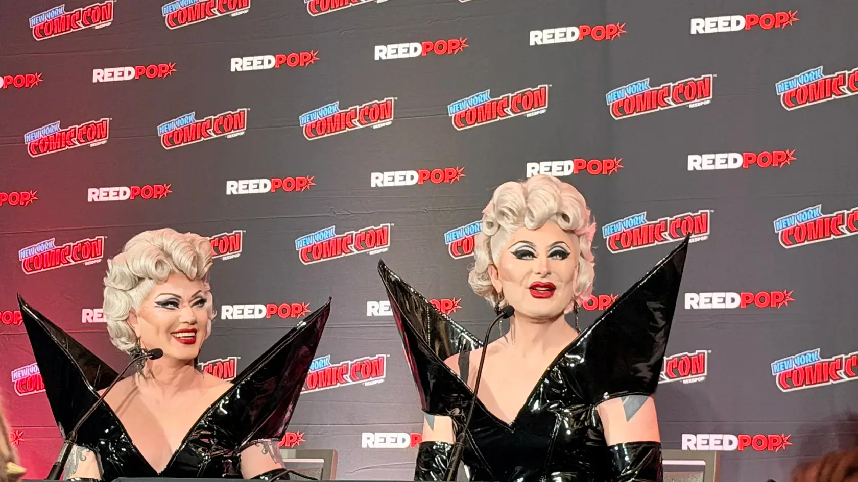 Two drag queens in black dresses.