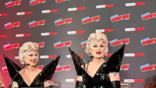 Two drag queens in black dresses.