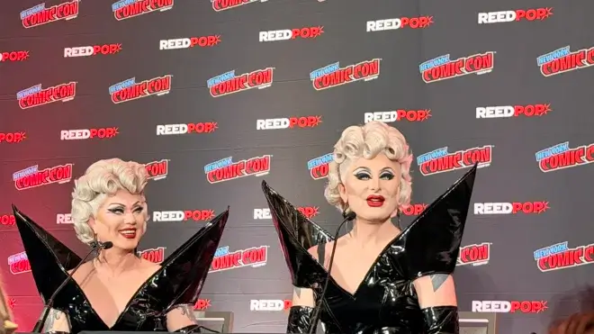 Two drag queens in black dresses.