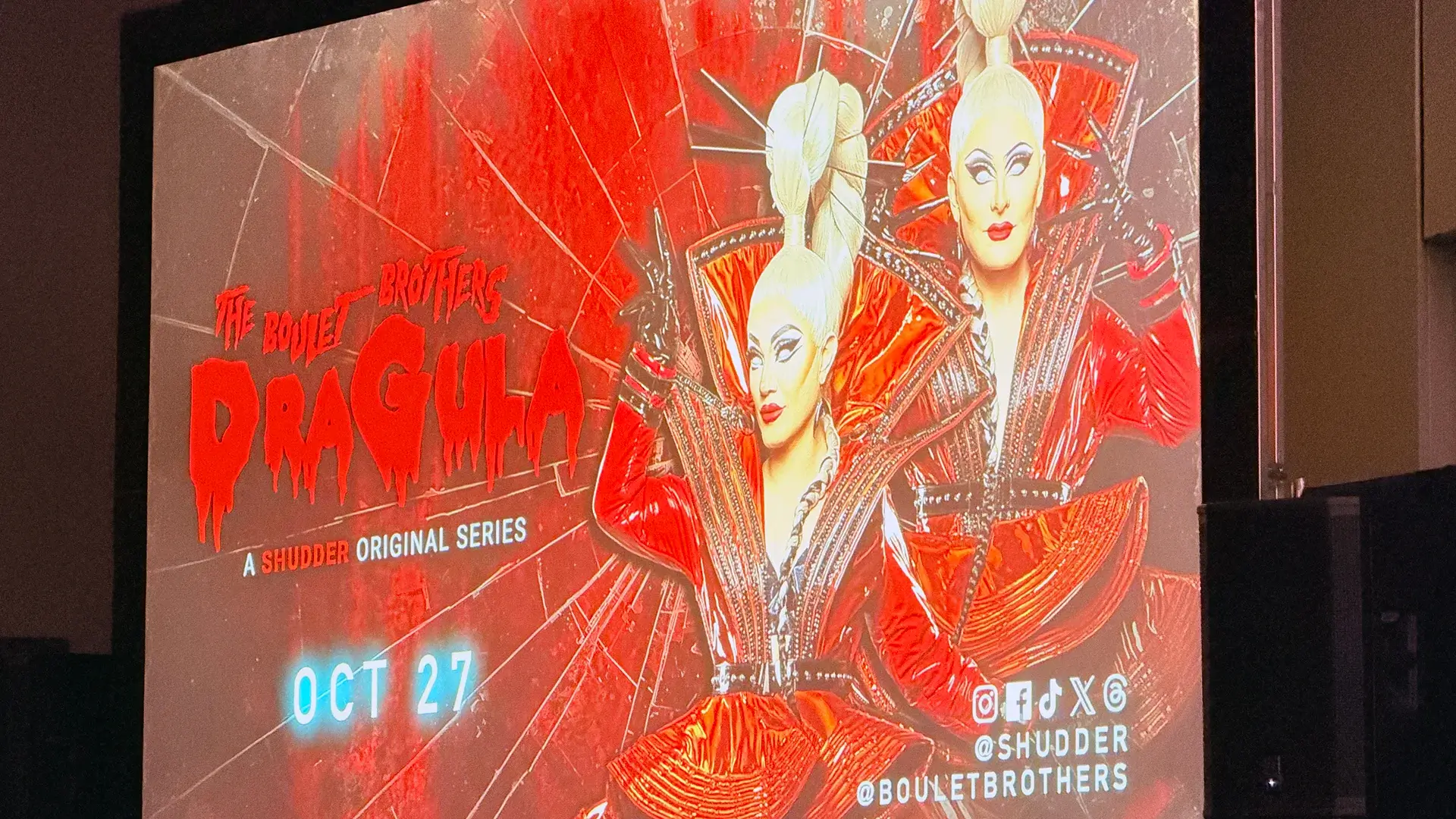 A screen featuring two blonde drag queens.